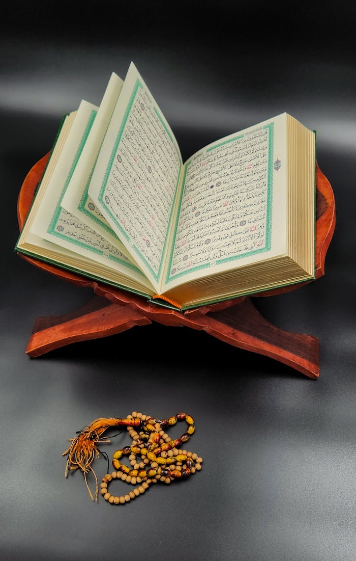 Crafting Captivating Headlines: Your awesome post title goes here An open Quran on a wooden stand with prayer beads symbolizes devotion and worship.
